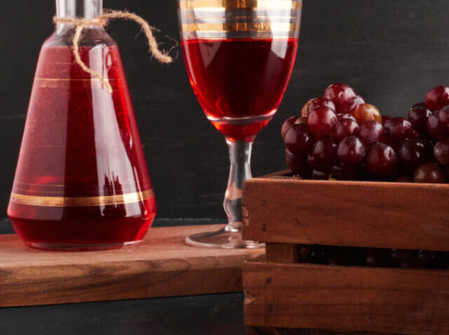 cropped-red-grape-bunches-wooden-tray-with-glass-wine-black-1-1.jpg