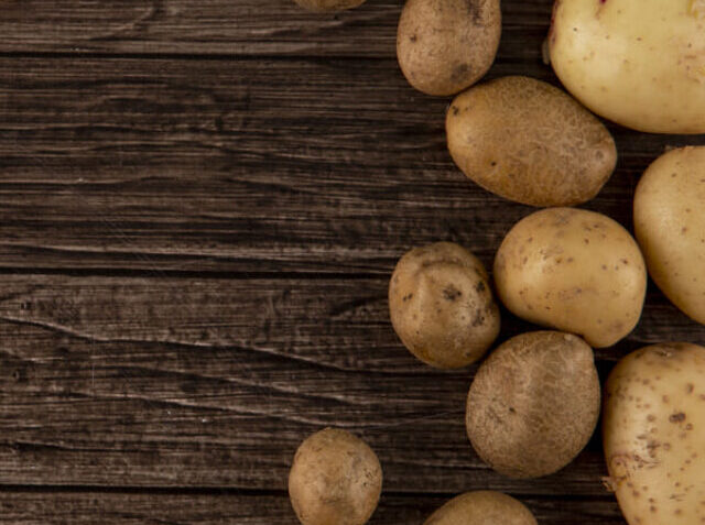 top-view-raw-potatoes-with-copy-space-wooden-background (1) (1)